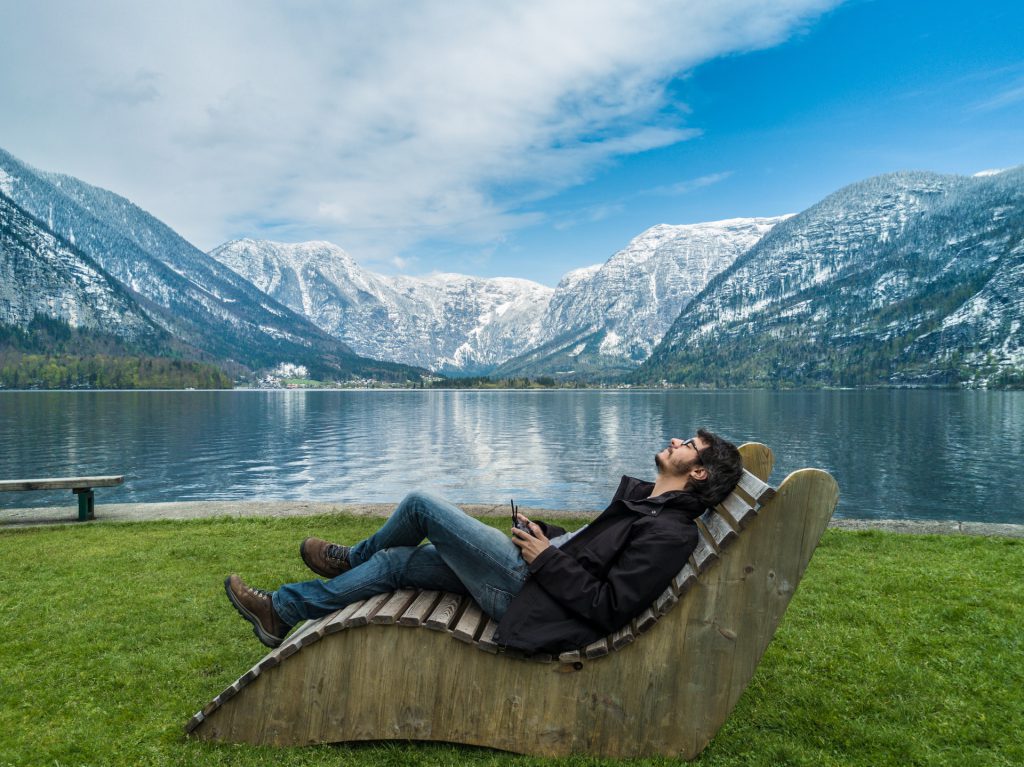 Man sitting next to Hallstatt, Austria lake