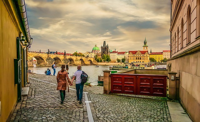 A couple strolling and holding hands on the streets of Prague
