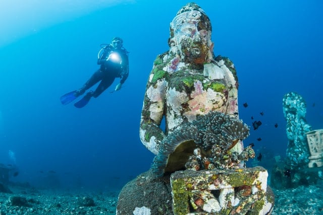 Diving near mind-blowing Buddha statues on Bali