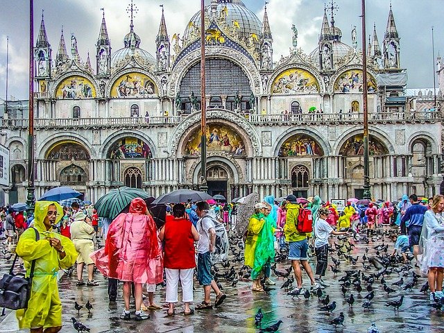 Colorful people out Saint Mark's Basilica in Venice Italy
